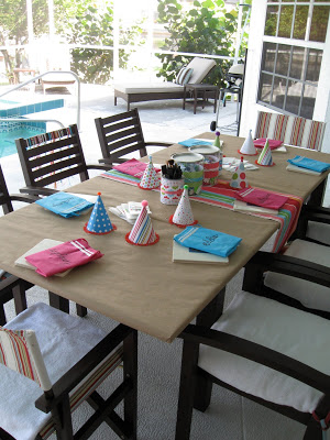 The crafty birthday party table was set up next to the pool. 