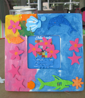 Kids decorated frames with beachy accessories to go with the crafty birthday pool party theme.