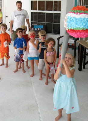 All the kids lined up to take a swing at the pinata. 