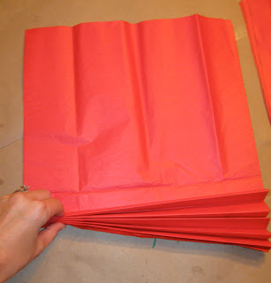 Fold the sheets of tissue paper into a fan pattern 