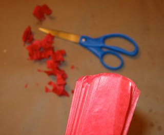 Use scissors to snip the ends of this tissue paper party balls. 