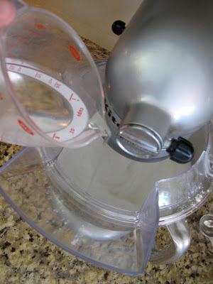 Add icing ingredients to the mixer for your sugar cookies. 