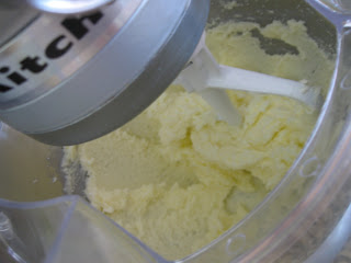 Beating the butter until it gets fluffy using a Kitchen Aid mixer. 