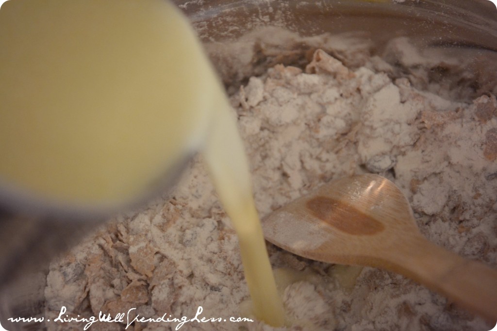 Add the wet ingredients into the dry ingredients, using a spoon to fold them together. 