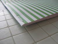 A green striped card stock is festive for the Christmas season. 