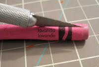 Begin by slicing the wrapper off each crayon using an Exacto knife. 