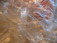 Candy cane plastic wrappers in a pile.