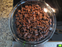Chocolate chunks in large glass bowl.