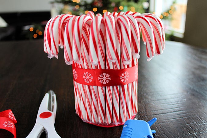 Looking for the perfect holiday centerpiece? This easy DIY candy cane vase is a budget-friendly project that will be the star of your holiday table!