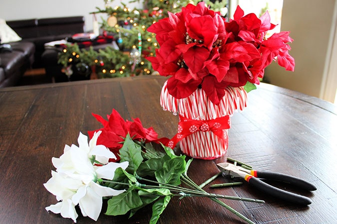 Looking for the perfect holiday centerpiece? This easy DIY candy cane vase is a budget-friendly project that will be the star of your holiday table!