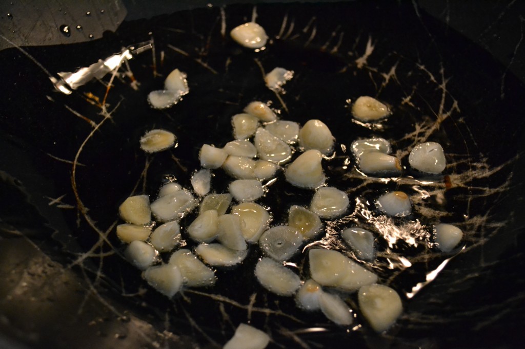 Saute garlic in a wok with plenty of olive oil. 