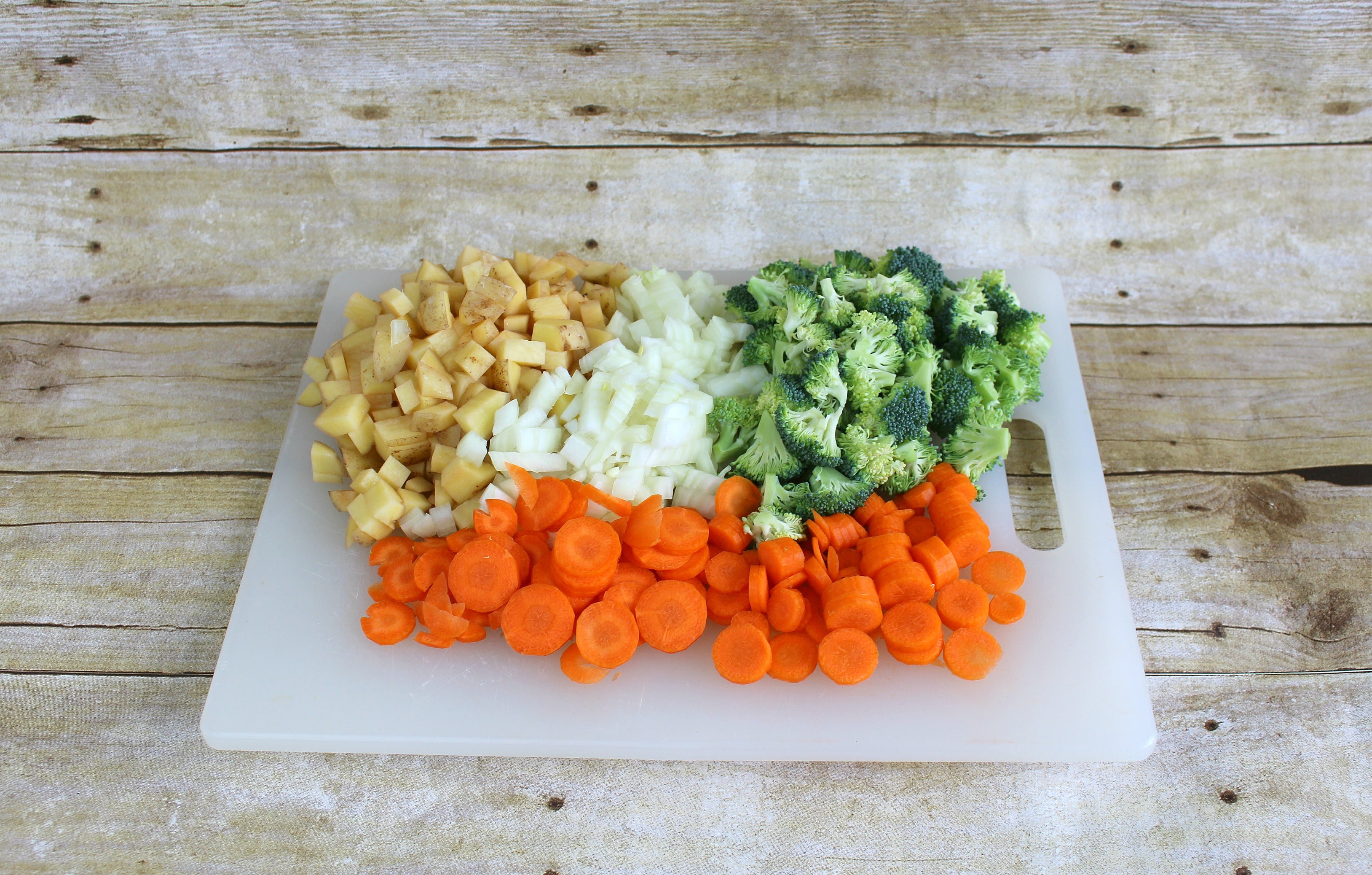 Step 1 of the Roasted Vegetable Pot Pie Pockets recipe is to chop the vegetables.