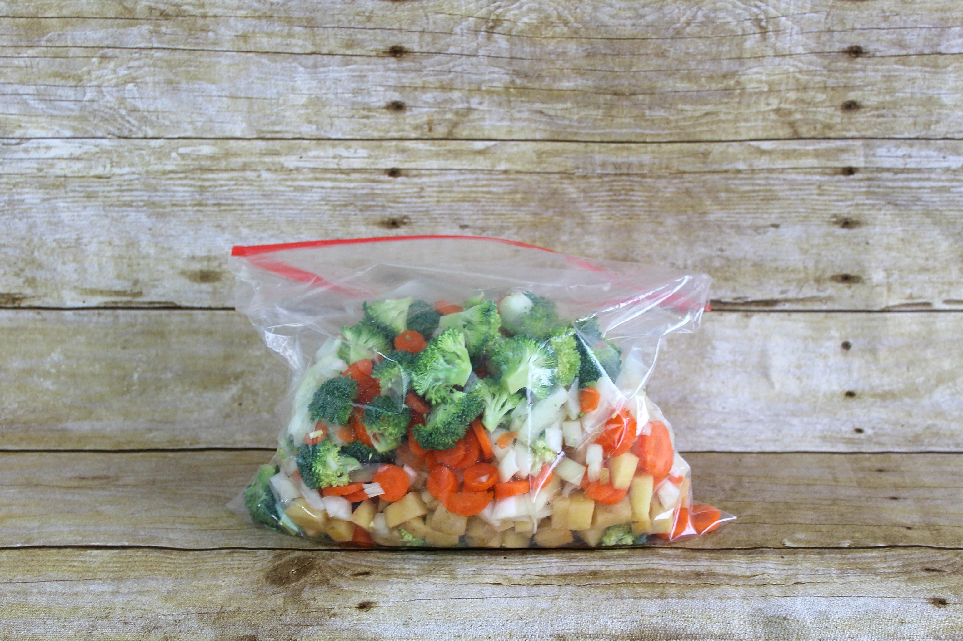 Step 2 of the Roasted Vegetable Pot Pie Pockets Recipe is to place the veggies in a gallon size bag.