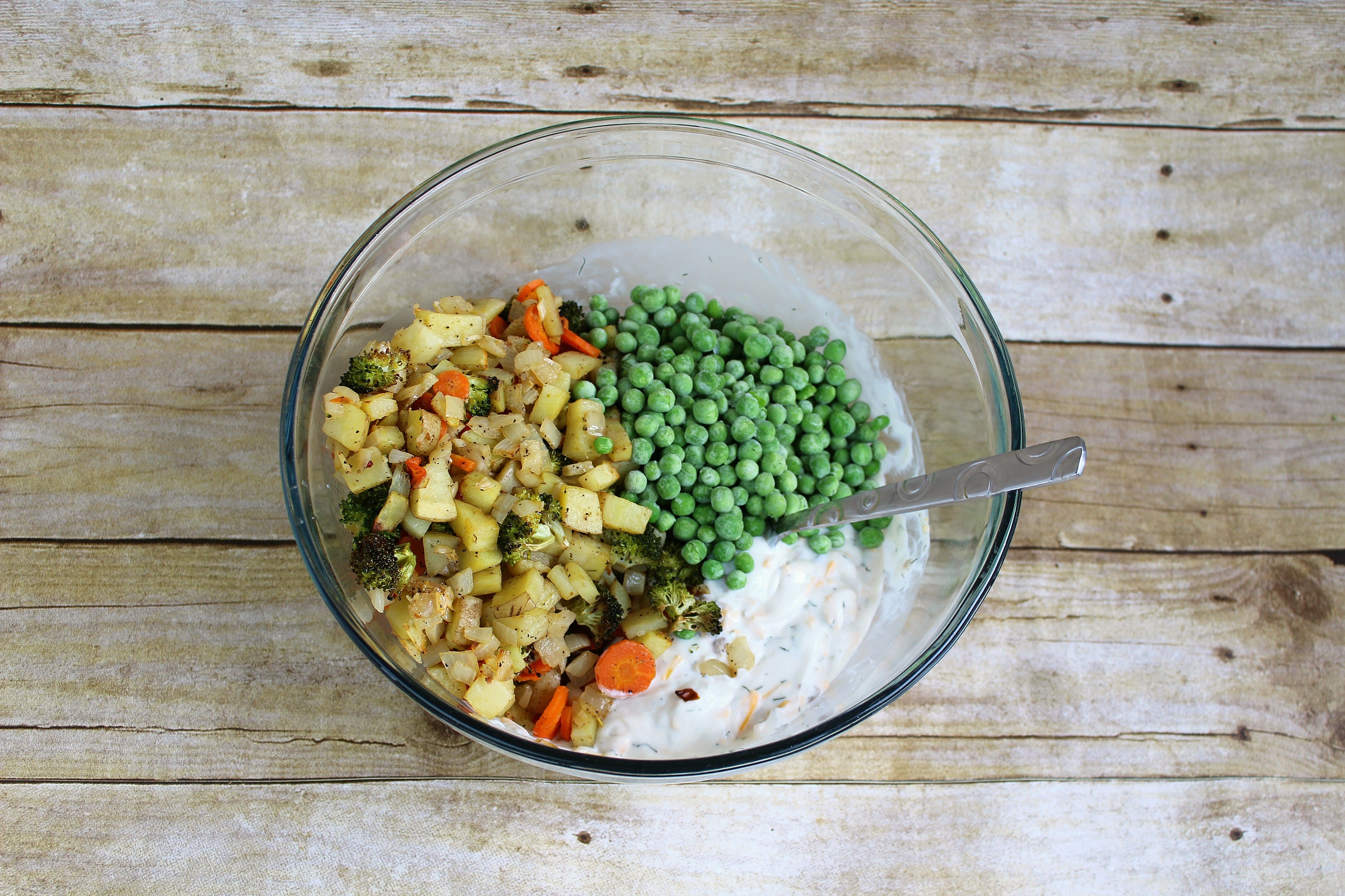 Step 5 of the Roasted Vegetable Pot Pie Pockets recipe is to mix the cooled veggies and other ingredients together in a bowl.