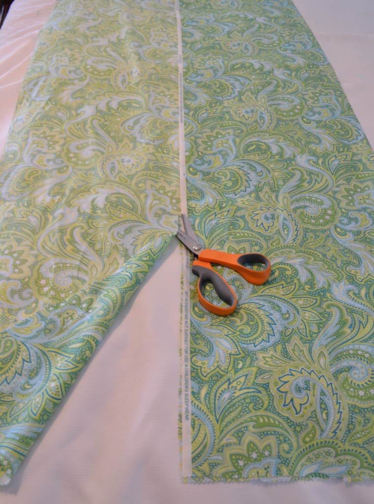 Measure your table runner lengthwise and cut down the middle with your sheers. 