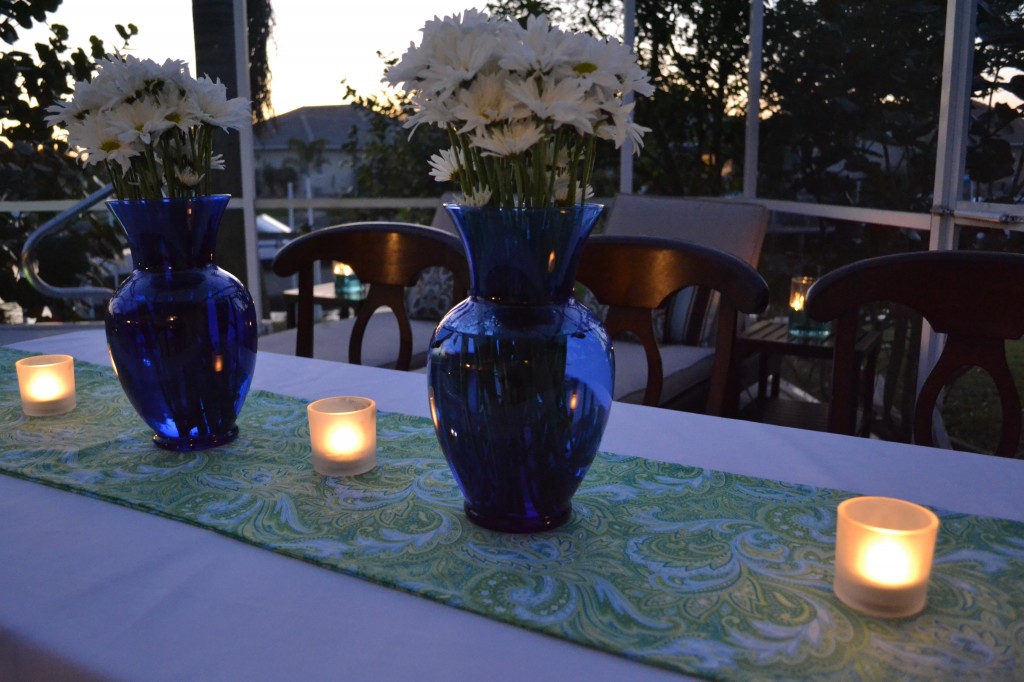 The paisley fabric for this table runner cost just a few dollars and looks great with the tea light candles and bouquets of daisies in blue vases. 