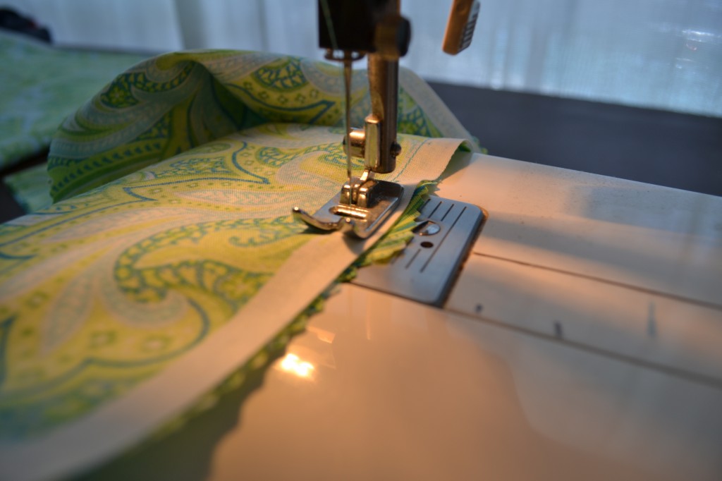 Sew the sides of your table runner together with a sewing machine. 