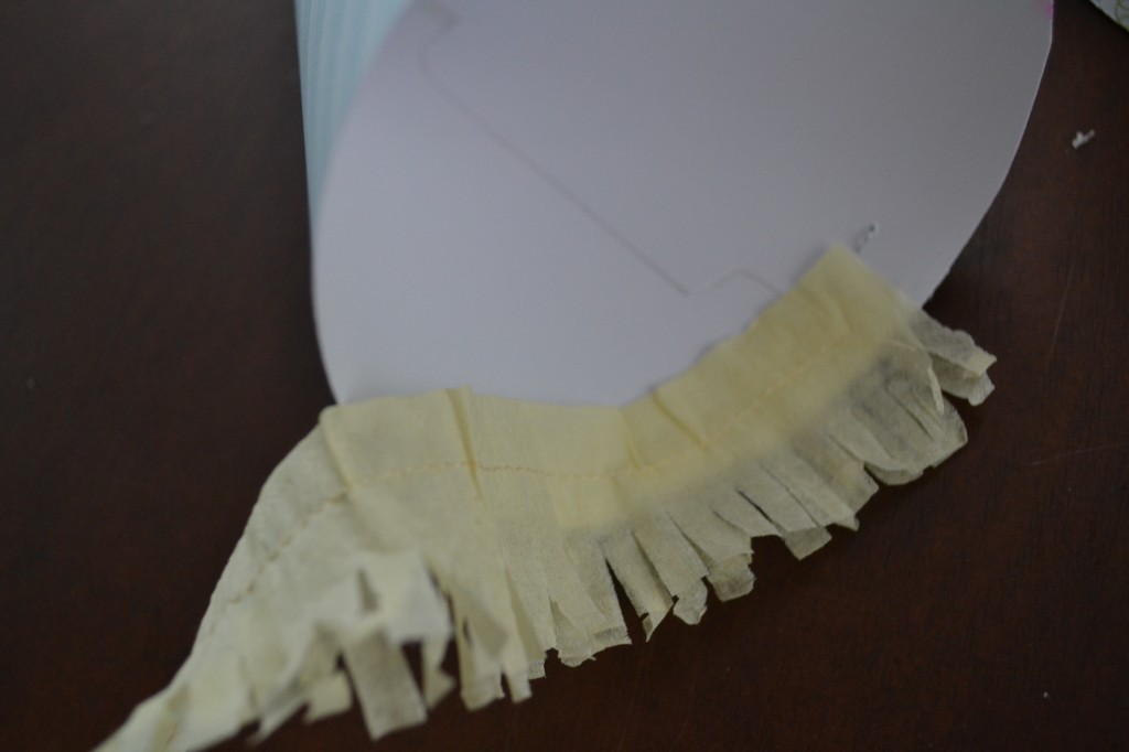 Glue the cute sewn fringe to the edge of your DIY paper party hat. 