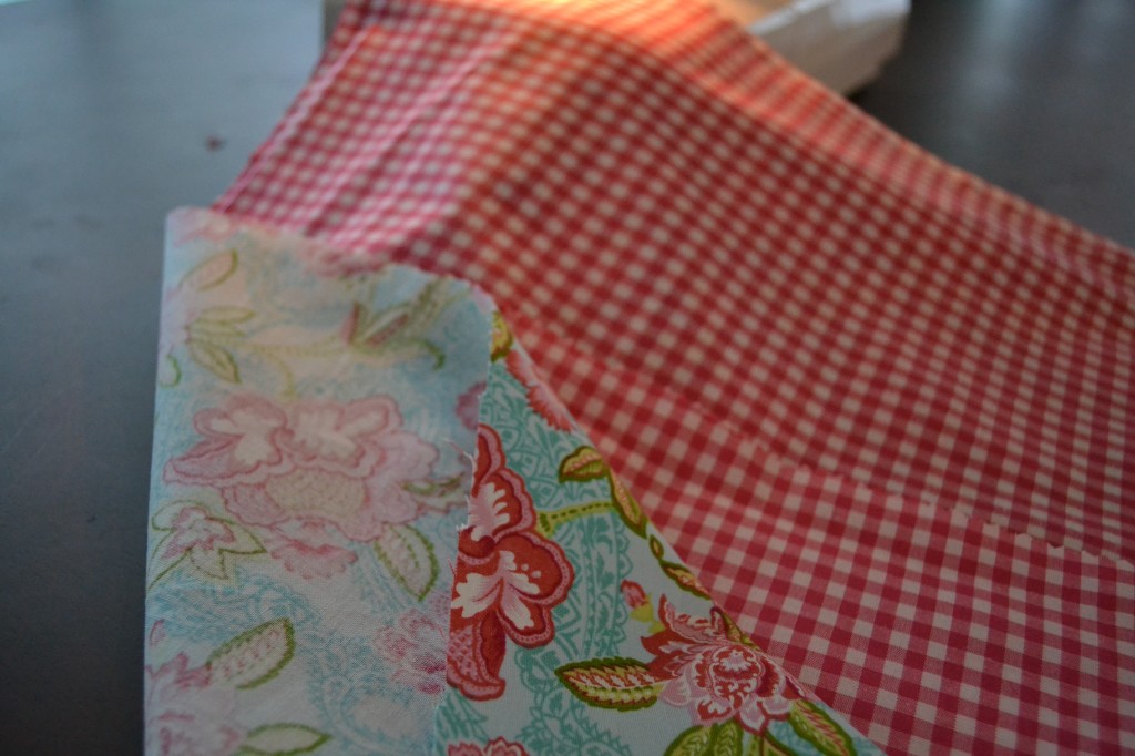 One of the first steps for this DIY Simple Chair Slipcover is to measure and cut the fabric (use contrasting patterns if you'd like!). 