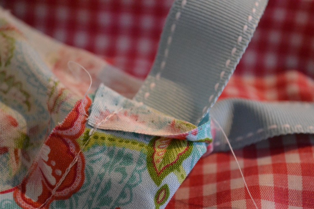 Add the ribbon to the DIY Simple Chair Slipcover. 