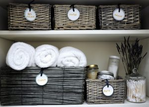 organize towels and other bathroom things in cute baskets and jars.