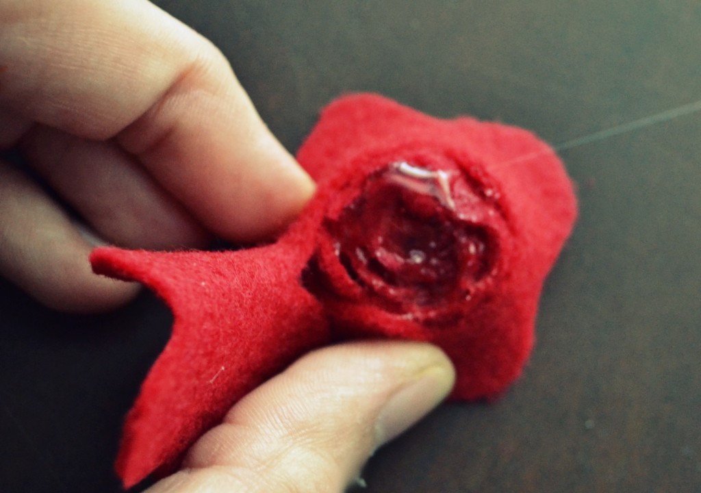 When you get to the end, hold in place with hot glue and use the center of felt circle as the base of the flower.