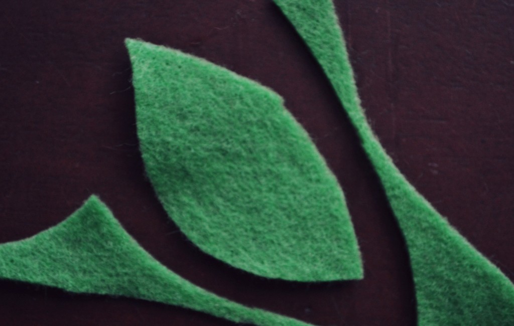 Cut leaf shapes out of green felt.