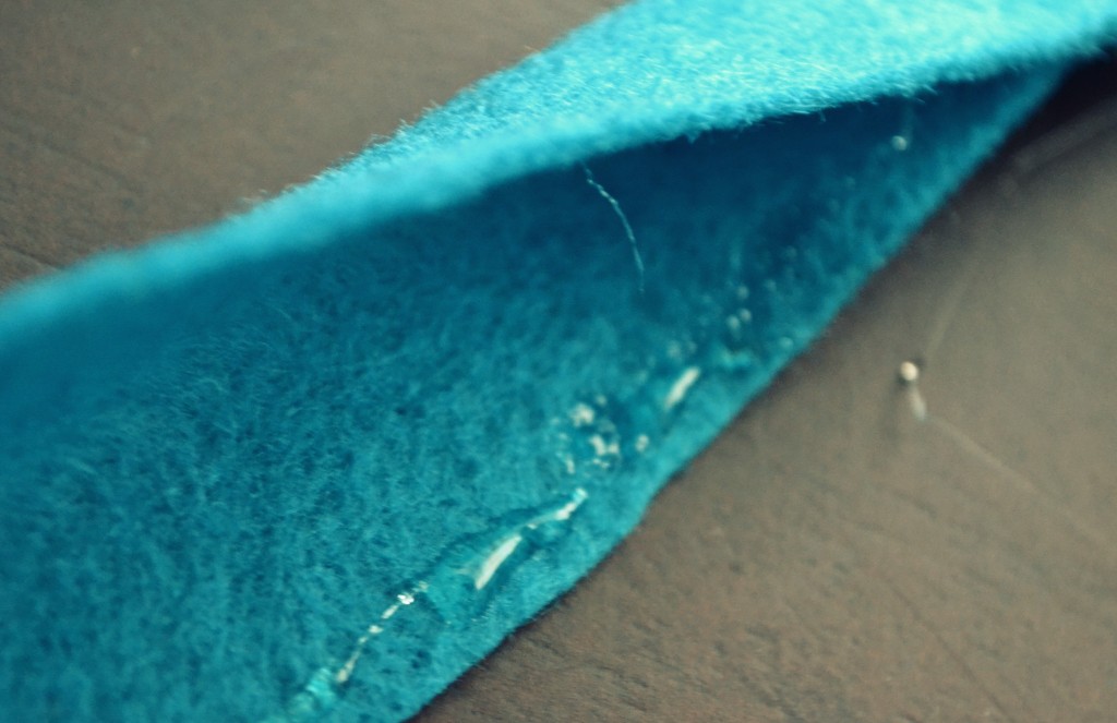 Glue long piece of blue felt together at edges to make a loop.