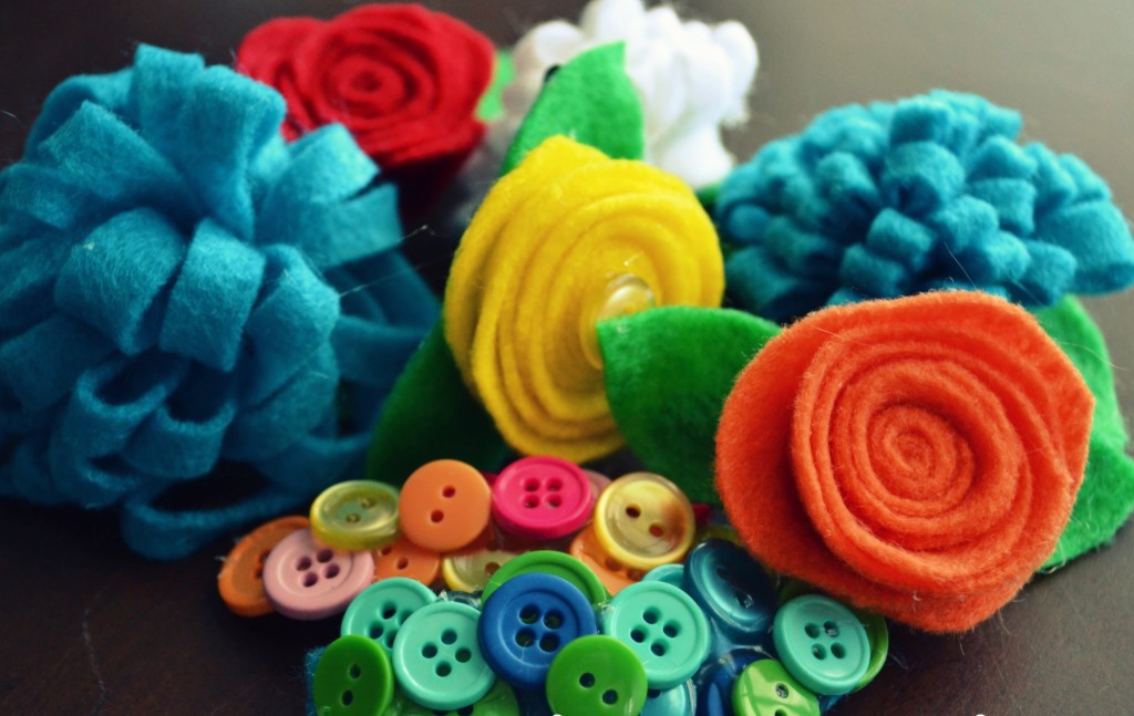 Arrange felt flowers and buttons in any way you'd like onto clips.