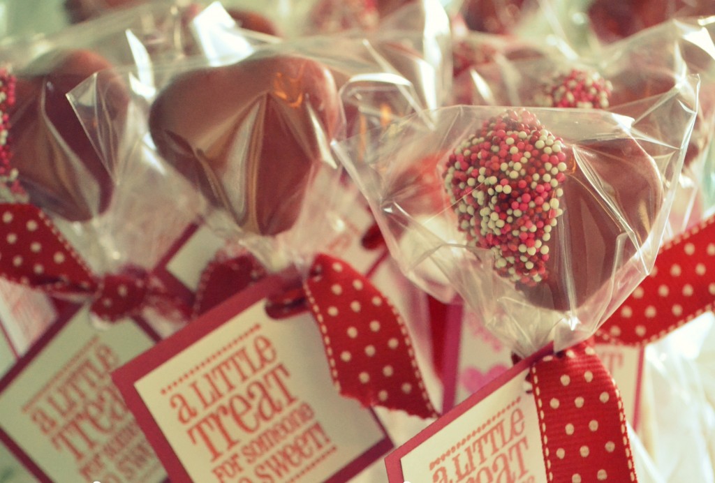 Assemble the finished Valentine's Day cake pops with plastic wrap, a ribbon, and a sweet note. 