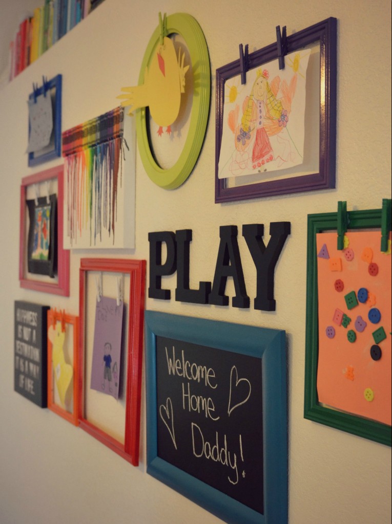 The kids artwork graces the wall of the rainbow play room