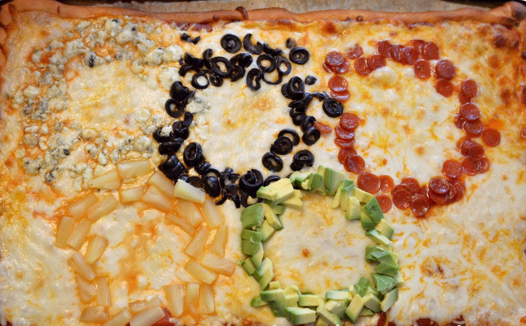 This homemade Olympic ring pizza made from blue cheese, olives, pepperoni, pineapple and avocado is delicious.