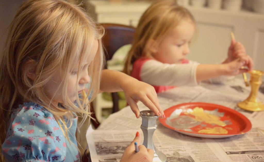 Apply at least three coats of metallic paint to candlesticks using brushes. 