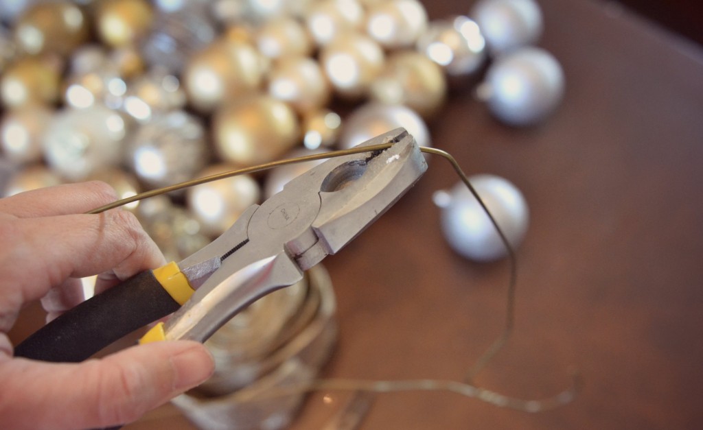 Use a pair of pliers to shape the wire hangers into a circle. 