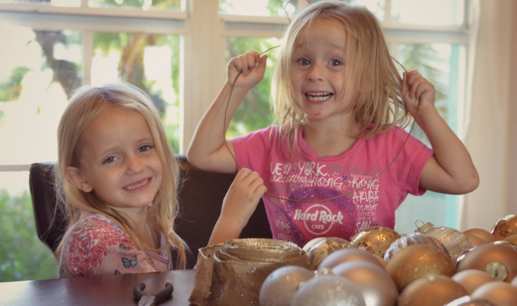 Get the kiddos involved in sliding the ornaments onto the undone wire hanger. 