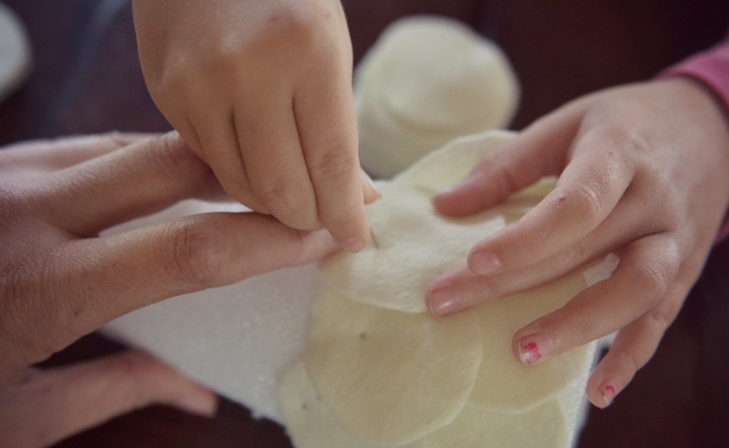 Hold the styrofoam cone as your kids pin the felt circles. 