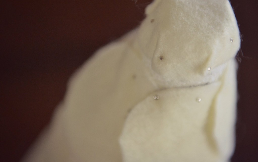 Use one felt circle to cover the top of the styrofoam cone. 