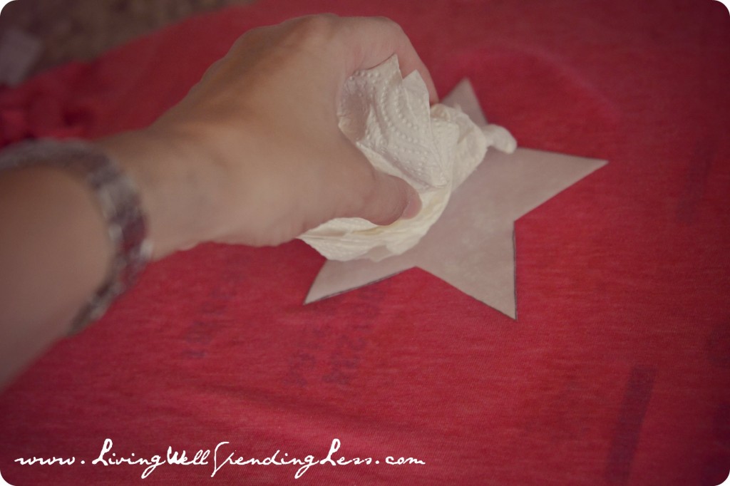 Blot excess bleach off of star shape on t-shirt using a paper towel. 