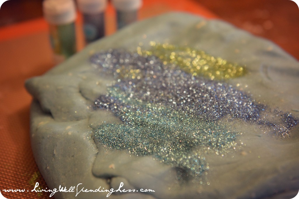 Sprinkle glitter on the playdoh lump and need together. Careful - this step can get messy!