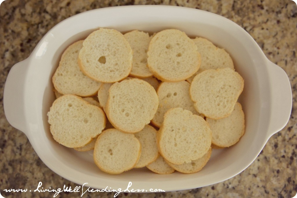 Lay out sliced pieces of bread into large greased casserole dish. 