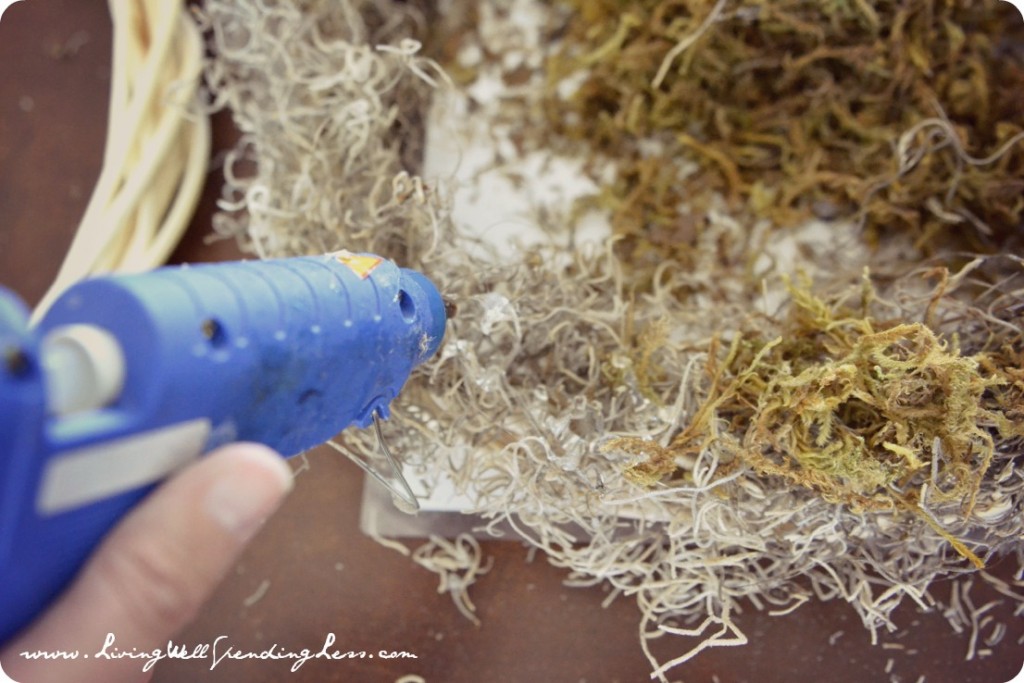 Continue to layer moss, generously spread hot glue over Spanish moss layer then secure green floral moss. 