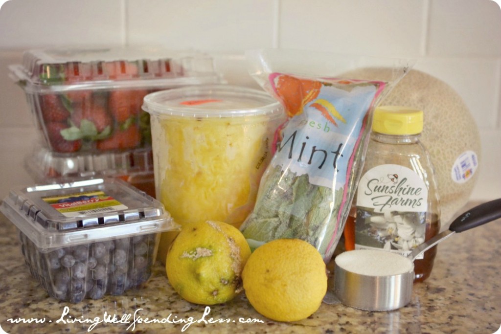 Assemble your fruit salad ingredients: fresh fruit, mint, sugar, water, honey and lemons.