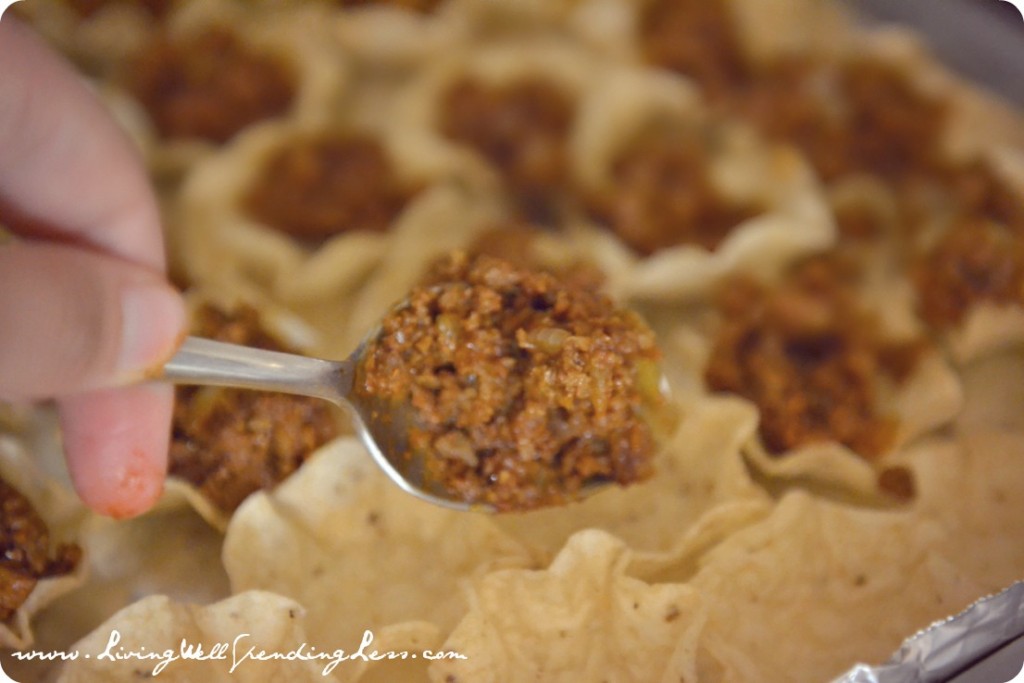 Use a teaspoon to fill each cup with taco meat mixture. 