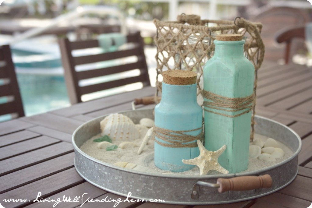 Table centerpieces were made of sand, "sea glass" painted jars, shells and twine. 