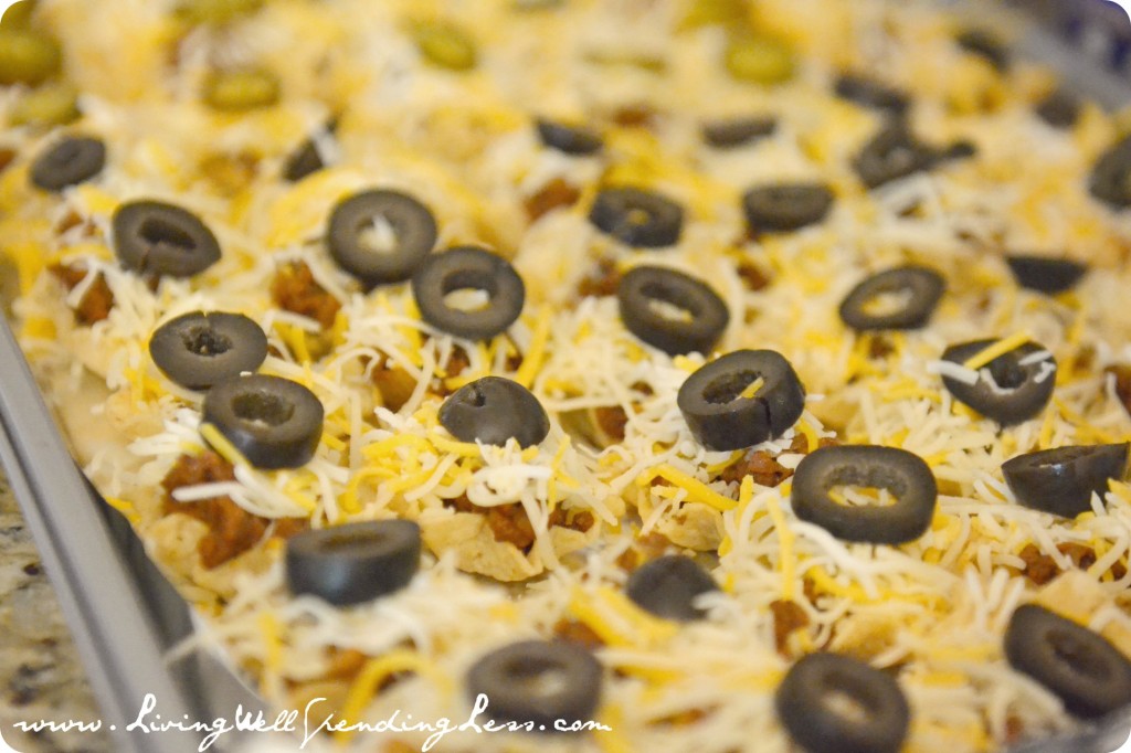 Sprinkle shredded cheese over taco meat then top each bite with a sliced olive.