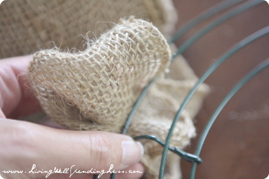 Start by weaving the burlap around and through the wires of the metal wreath frame. 