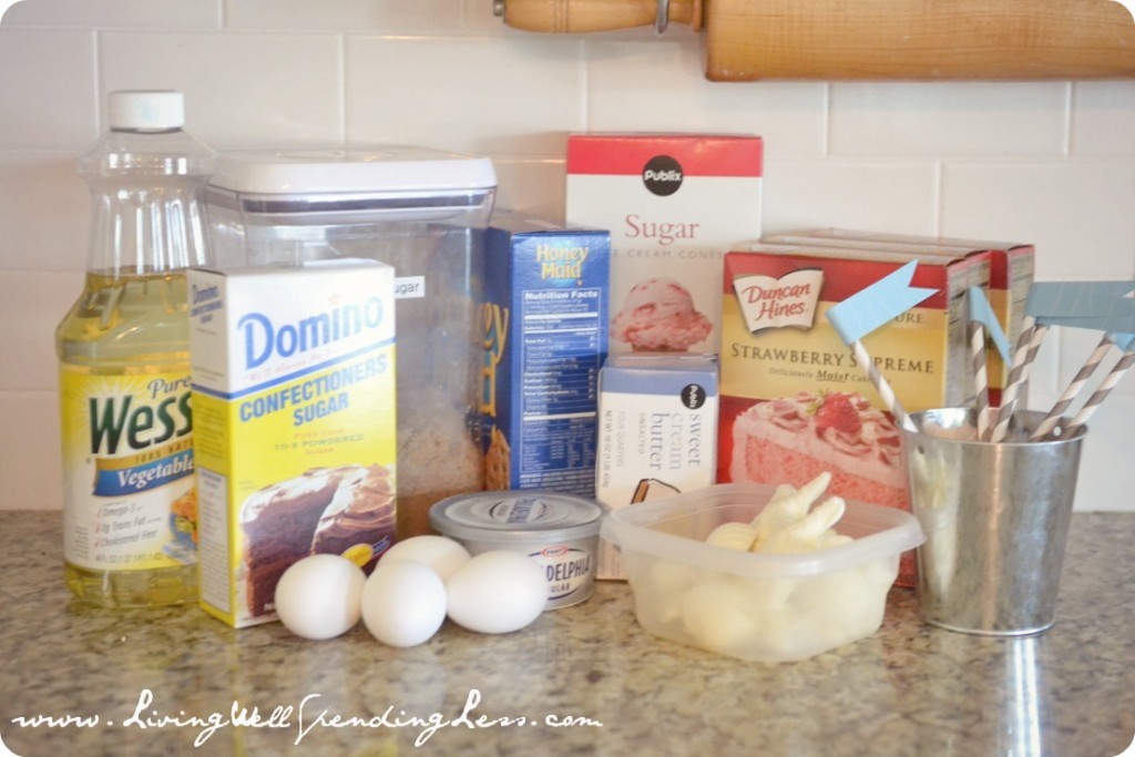 To make a sandcastle cake, assemble the ingredients: cake mix, eggs, butter, cream cheese, confectioners sugar, oil and graham crackers. 