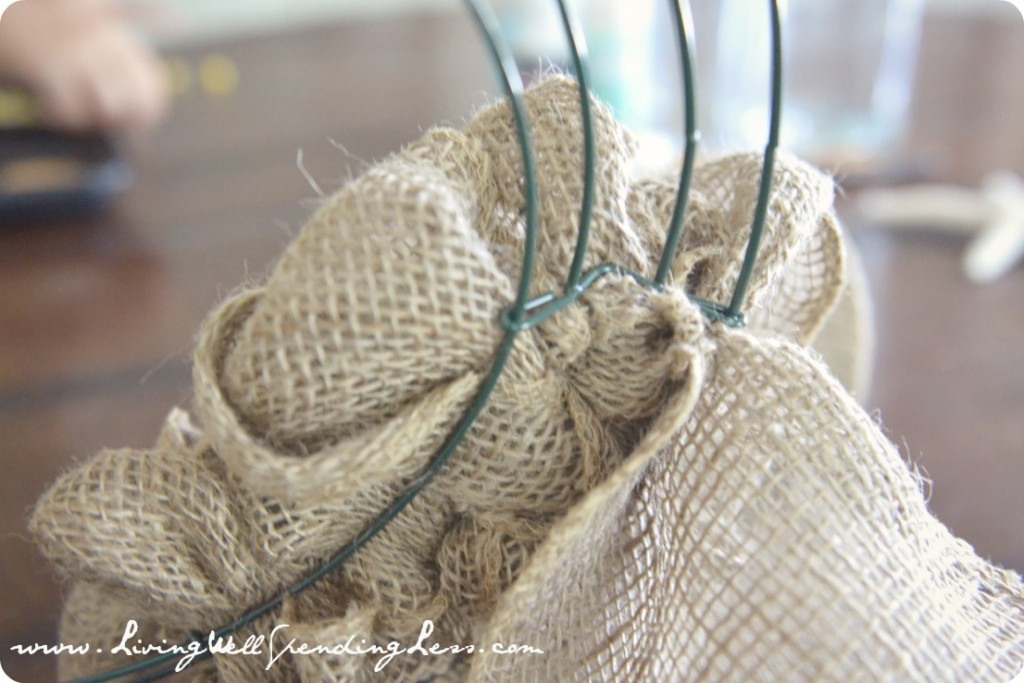 Wrap the burlap fabric all the way around the wreath frame. 