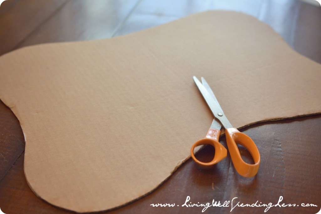 Cut a large cardboard base for your sandcastle cake. 