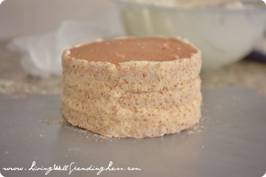 Layer the three 6 inch cakes, frost and cover with graham cracker sand.